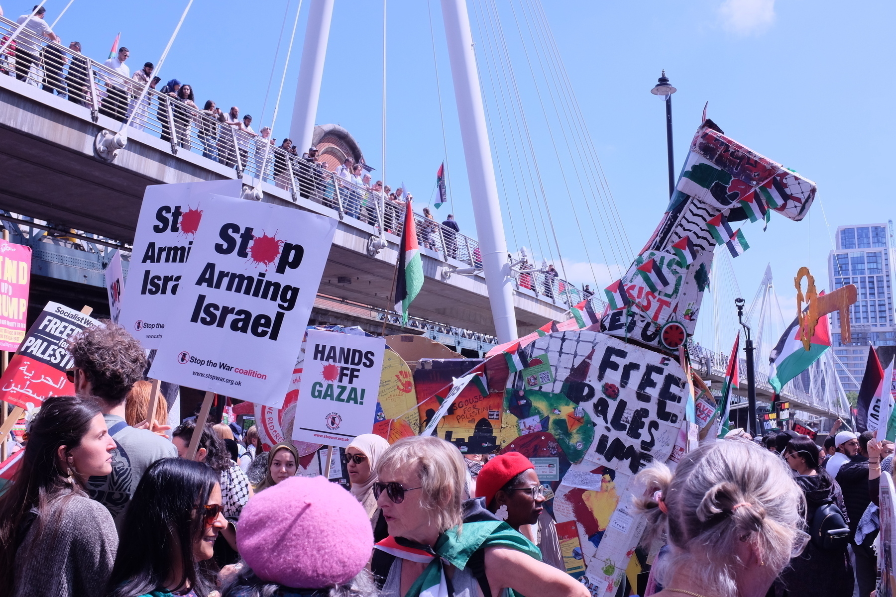 A giant, decorated model of a Palestinian horse stands in the middle of the demonstration by Waterloo Bridge in London